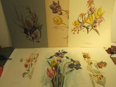 three paintings of flowers and butterflies on a table