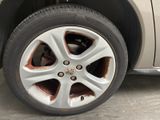 a dirty tire on a car that is parked in a garage