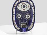 an image of a blue and white mask on a white pedestal