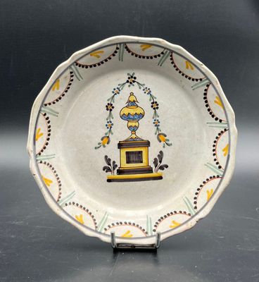a small plate with a picture of a vase on it