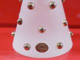 a white cone with silver studded decorations on it
