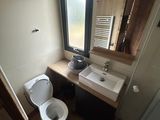 a bathroom with a toilet, sink, and mirror in it