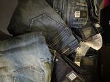 a pile of jeans and other clothing on a table