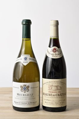 two bottles of wine sitting on a wooden table next to each other