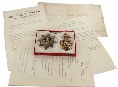 a small box with two medals on top of a piece of paper
