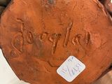 a person holding a piece of wood with writing on it