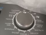 a close up of a button on a washing machine