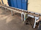 an image of a long wooden bench in front of a building