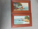 two paintings of a beach scene are hanging on a wall