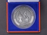 a close up of a medal in a blue box on a table