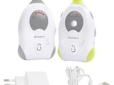 two white and green electronic baby monitors and a charger