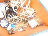 a box full of assorted jewelry on a table