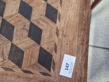 a wooden table with a checkered pattern on it