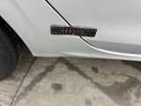 a sticker on the side of a white car
