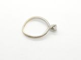 silver ring with a knot on top of it on a white surface