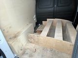 the interior of a van with a bed in the back of it