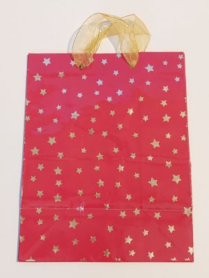 red gift bag with gold stars on it on a white background