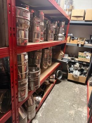 many pots and pans on the shelves in the store