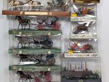 many different types of toy trains and carriages on display