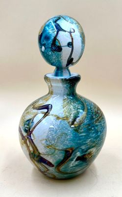 a glass bottle with a blue and white design on it