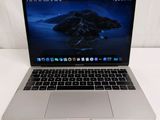 an apple macbook pro laptop computer sitting on top of a white table