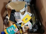 a cardboard box filled with various items and a hat