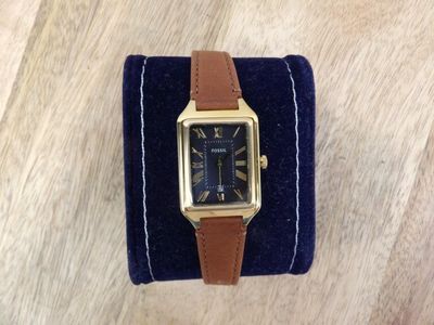 an image of a watch sitting on top of a blue velvet case