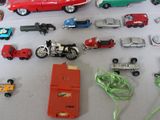 many different toy cars and trucks on a table