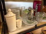 a shelf with dishes and cups on it in a kitchen