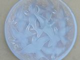 a glass plate with a design on it on a table