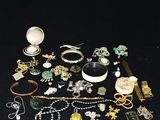many different types of jewelry on a black surface
