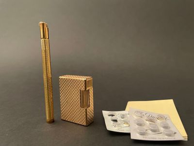 a gold lighter and a packet of cigarettes on a table