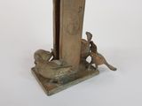 a bronze statue of a dog and a bird on a stand