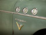 a close up of the emblem on the side of a green car