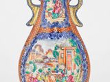 un vase avec un tableau posé sur une table