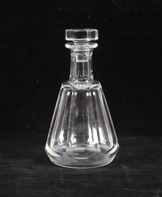un gros plan d'une bouteille en verre transparent posée sur une surface noire