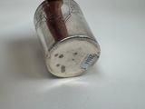 a silver cup with a brown handle on a white table
