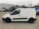 the white van is parked in a parking lot with other vehicles in the background