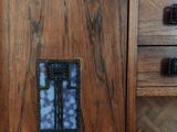 a wooden cabinet with a mirror on top of it