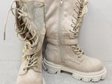 pair of beige combat boots with laces on the side