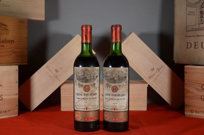 two bottles of wine sitting next to each other on a table
