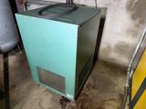 a green cabinet in the middle of a dirty room