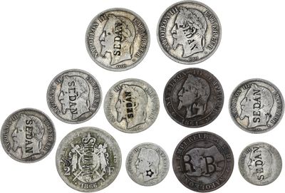 an image of a group of old coins on a white surface