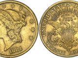a gold coin with a woman ' s head and eagle on it
