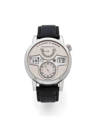 une photo d'une montre-bracelet avec un cadran blanc et un bracelet en cuir noir