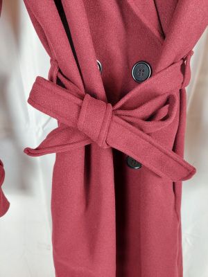 un gros plan sur un manteau rouge orné d'une cravate