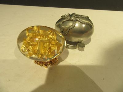 a small bowl of gold next to a small bowl of gold