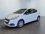 the small white car is parked in a large room
