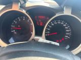 a close up of a car dashboard with gauges and a steering wheel
