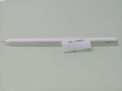 a white pen with a sticker on it sitting on a table
